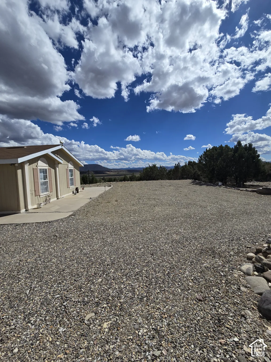 Gravel landscaping surrounding a single-story residence with a concrete path