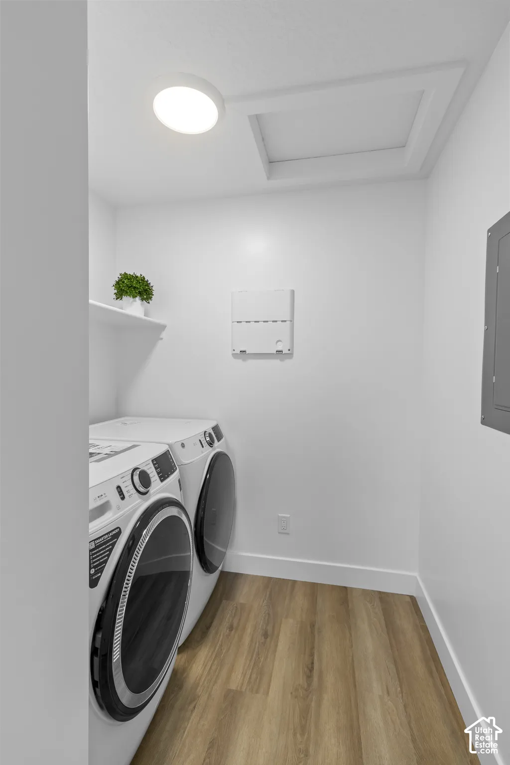 Wood-finish flooring, white walls, and a built-in white shelf