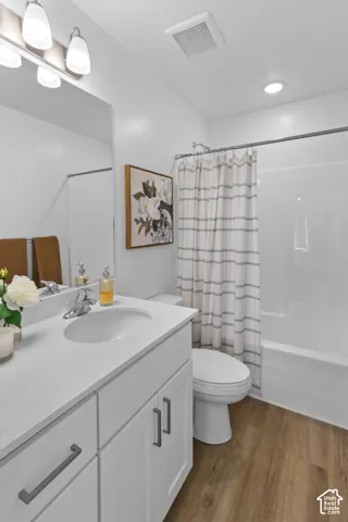 White vanity with a light-colored countertop, undermount sink, and chrome-finish faucet