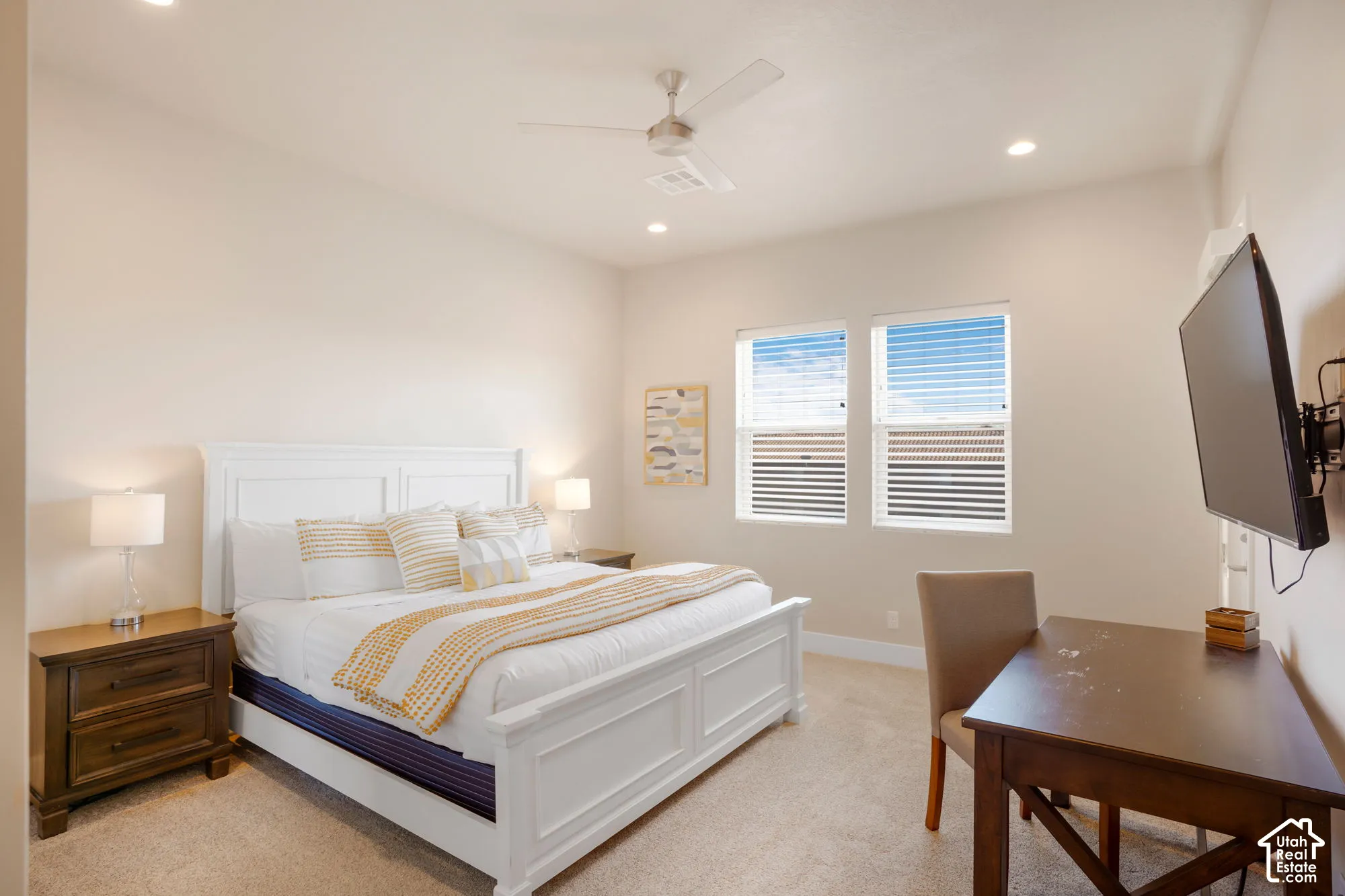 Two windows with blinds, recessed lighting, and a ceiling fan