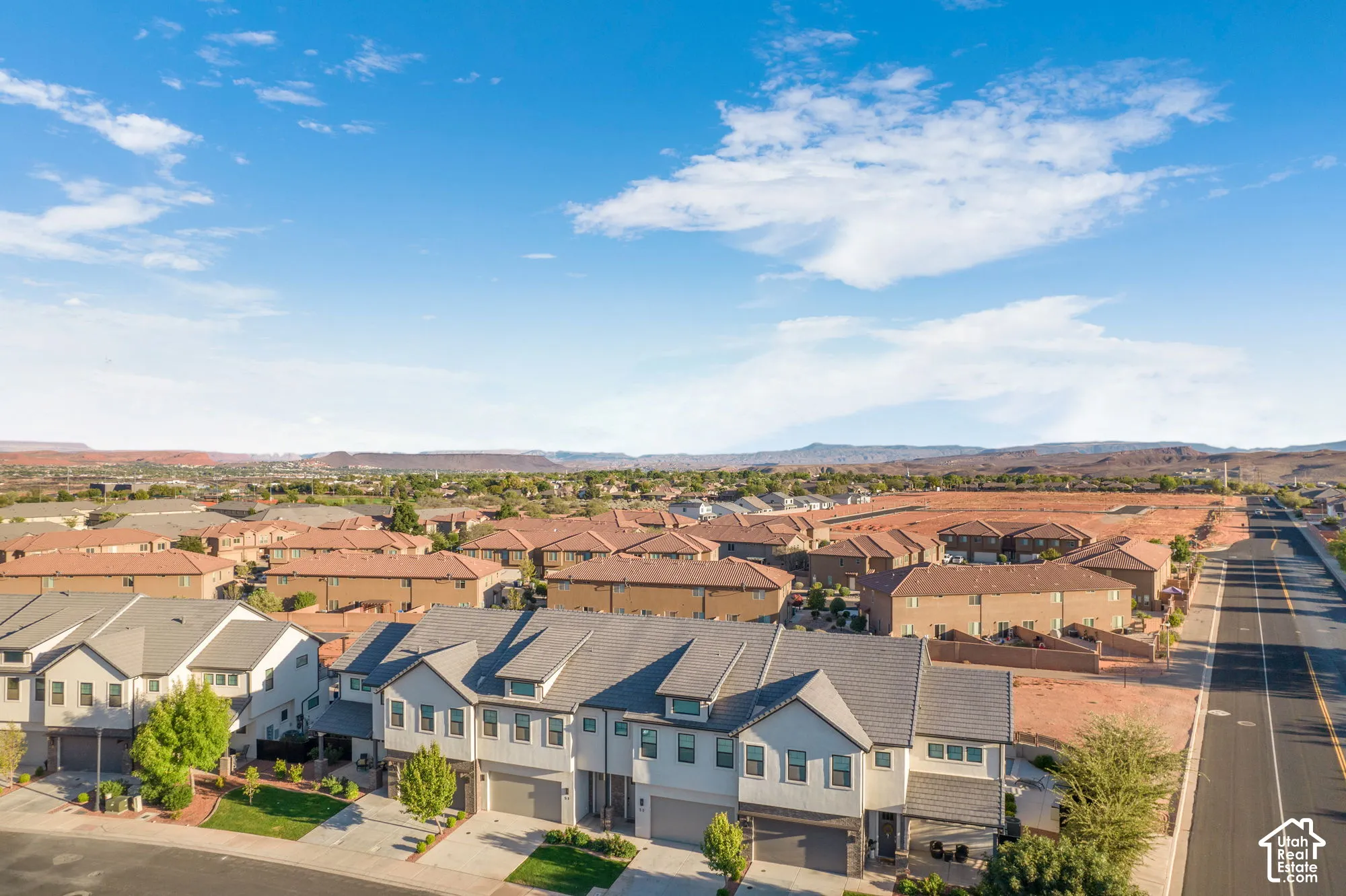 Community setting with mature landscaping, paved road access, and multiple residential structures