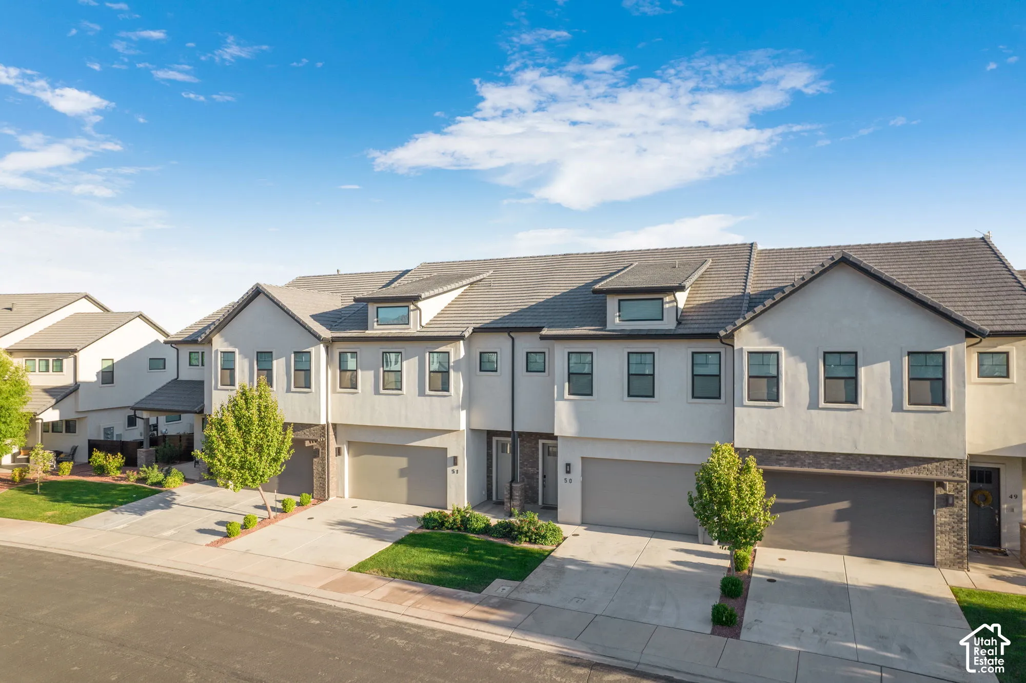 Contemporary townhome with stucco and stone veneer exterior
