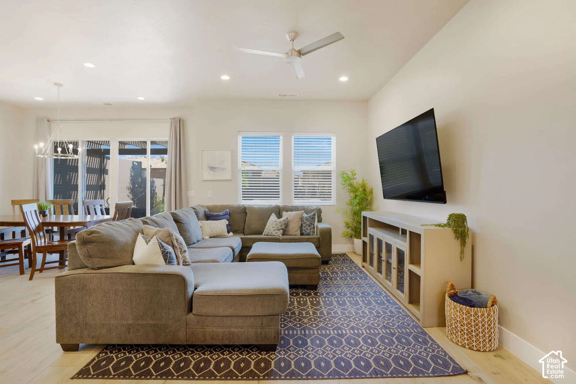 Recessed lighting, ceiling fan, wood-finish flooring, sliding glass doors, and multiple windows