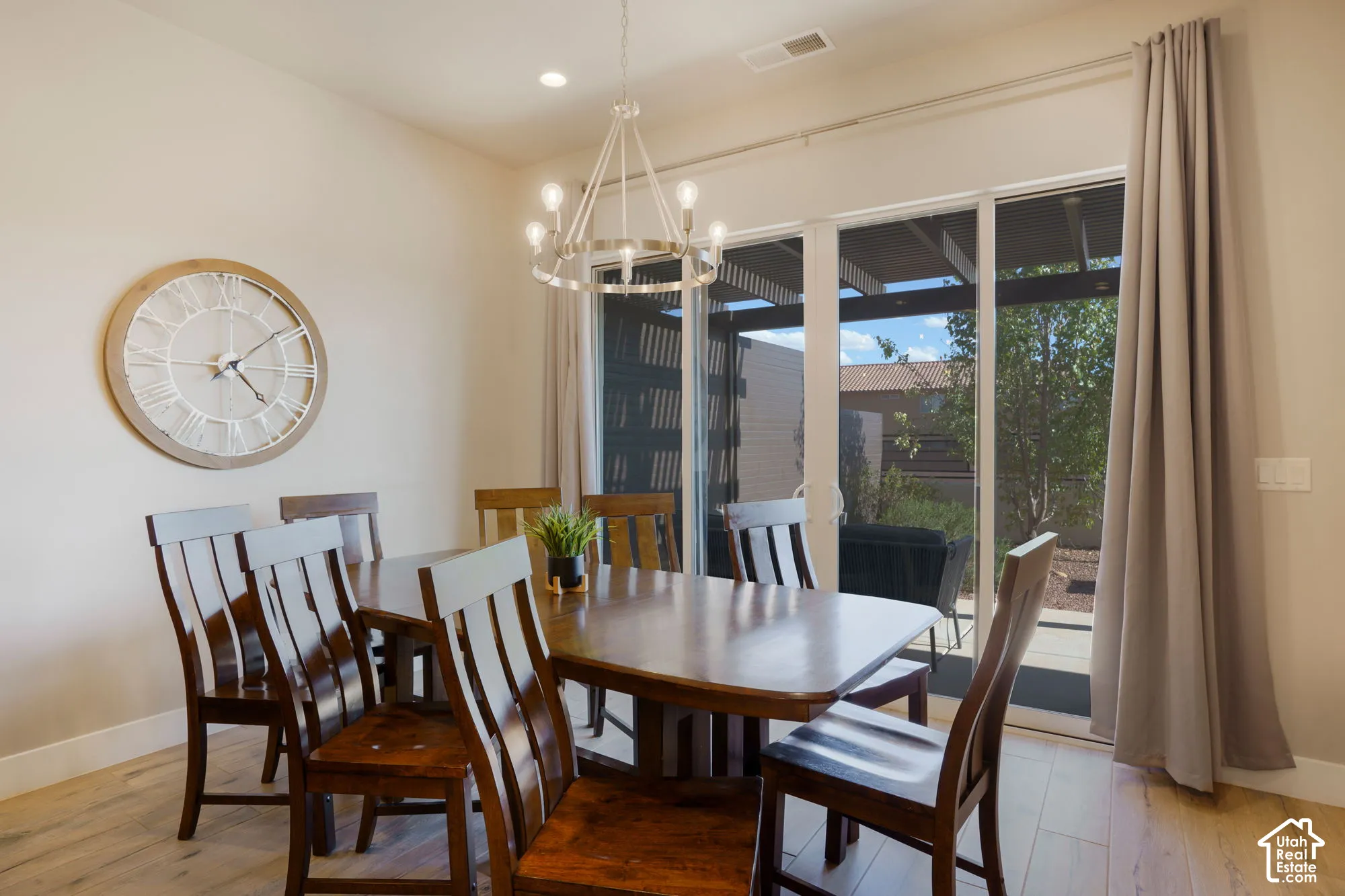 Recessed ceiling lighting, wood-finish flooring, and a contemporary chandelier