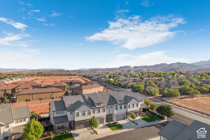 Townhome community featuring multi-story residences, attached garages, and landscaped front yards