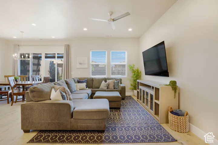 Recessed lighting, ceiling fan, wood-finish flooring, sliding glass doors, and multiple windows