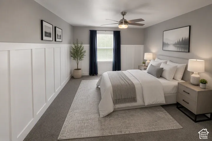 Board and batten wall detailing, window with blinds, ceiling fan, and carpeted flooring