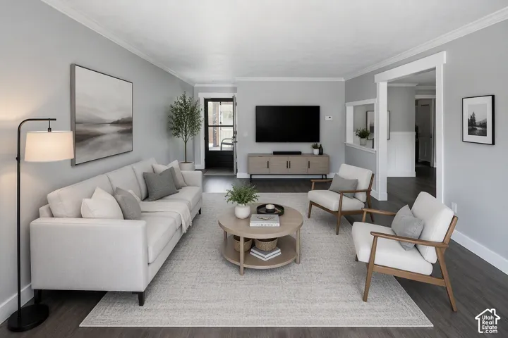 Crown molding, wood-finish flooring, white trim, recessed wall opening, and a built-in media console