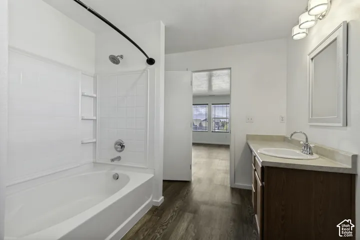 White-tiled bath and shower combination with chrome fixtures