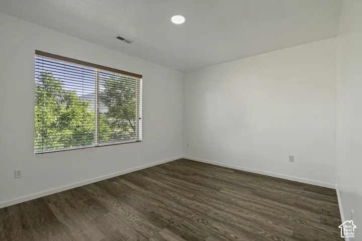 Wood-finish flooring, recessed lighting, and a window with blinds
