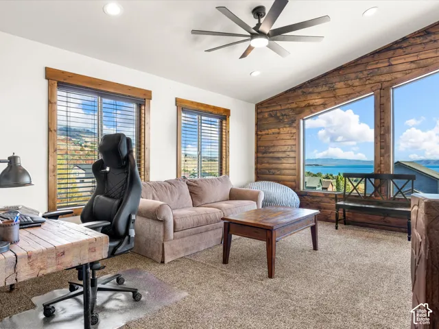 2nd floor family room lake view. Vaulted wood-paneled ceiling with a contemporary ceiling fan and recessed lighting
