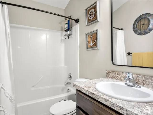 Cultured marble countertop with integrated sink, chrome faucet, and dark wood-finish vanity