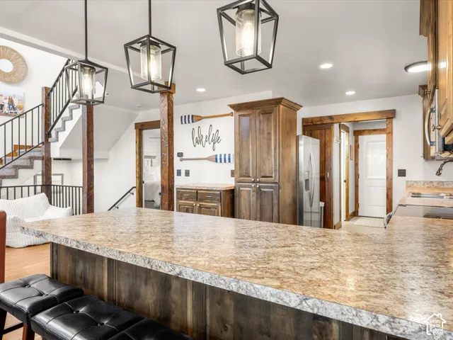 Kitchen island with a granite-look countertop and wood-finish paneling