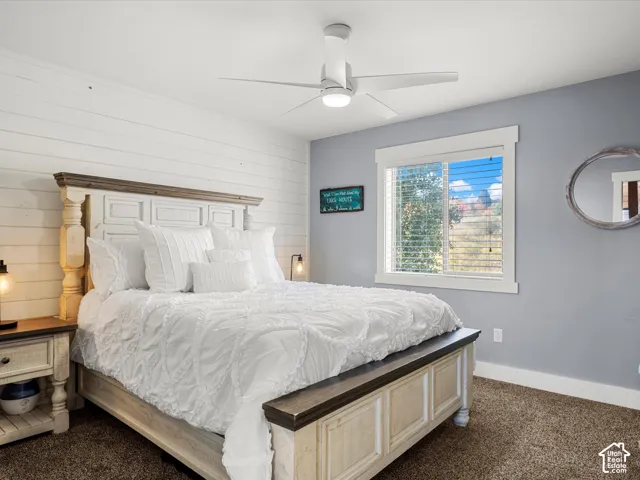 Master suite main floor.  Shiplap accent wall complemented by a contemporary ceiling fan with integrated lighting