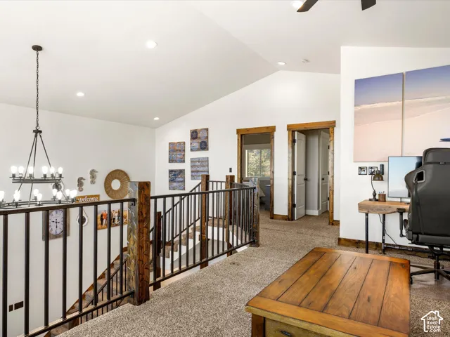 2nd floor family room. Open loft area with vaulted ceiling, recessed lighting, carpeted flooring, and wood-trimmed doorways