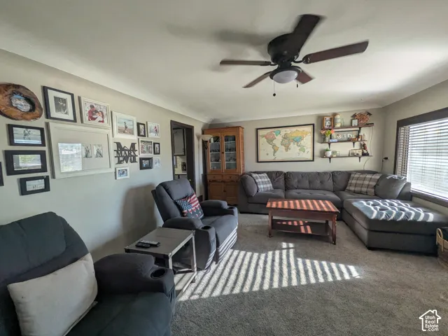 Recessed lighting, ceiling fan with integrated light, carpet flooring, window with blinds, and built-in shelving