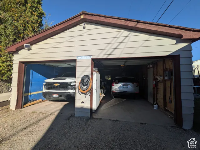 Two-car garage with siding exterior and a pitched roof