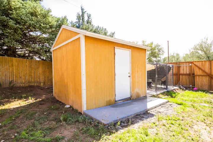 Freestanding shed with wood siding and white trim