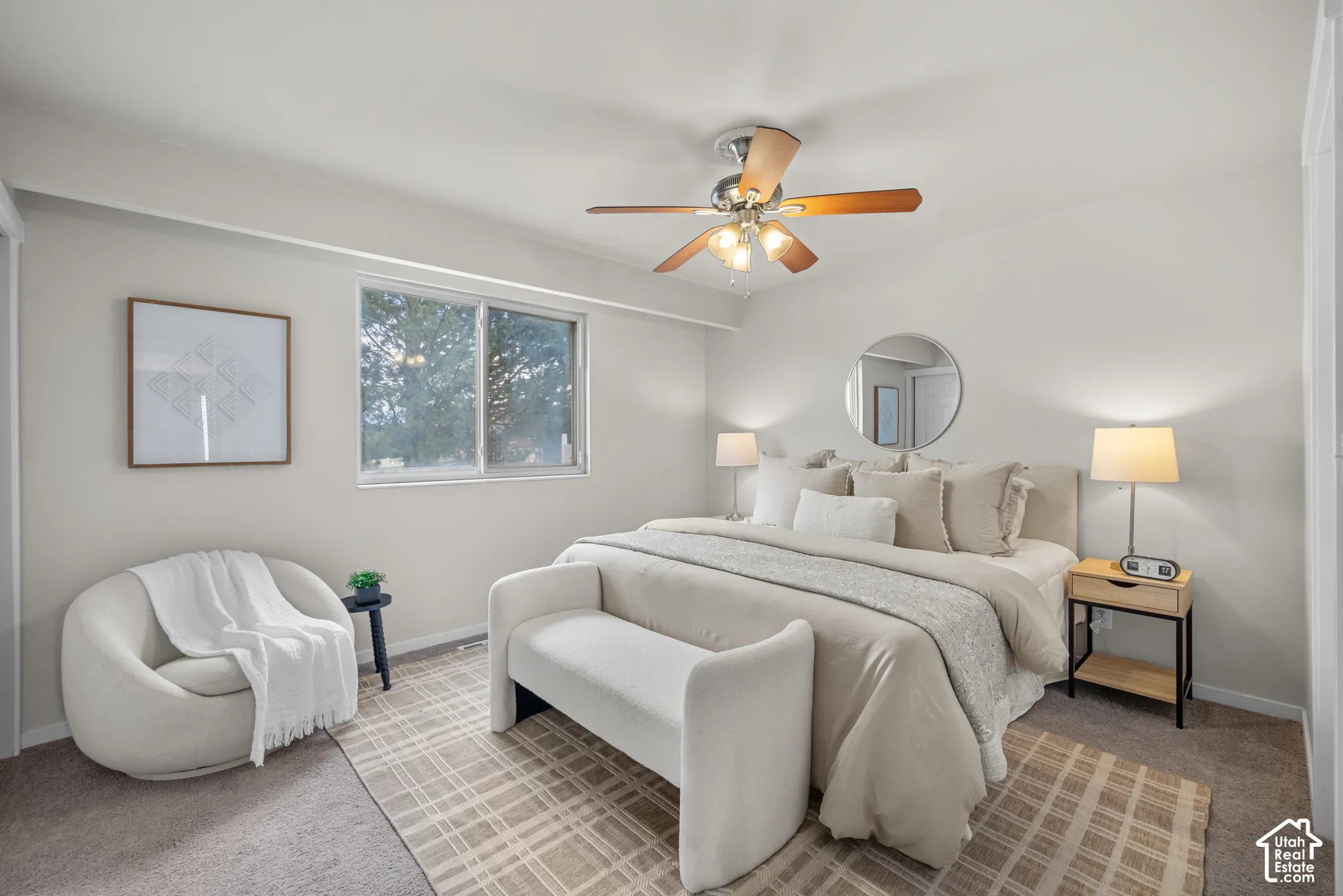 Expansive room featuring a ceiling fan with light fixture, large window, and carpeted flooring