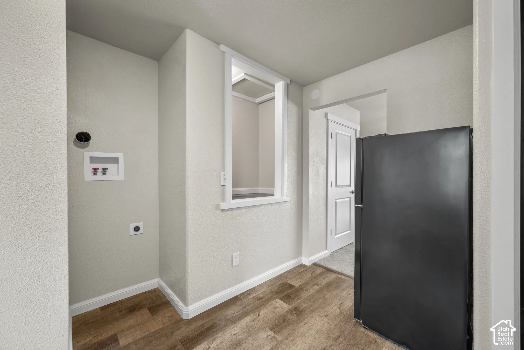 Wood-finish flooring, light gray wall paint, and white trim