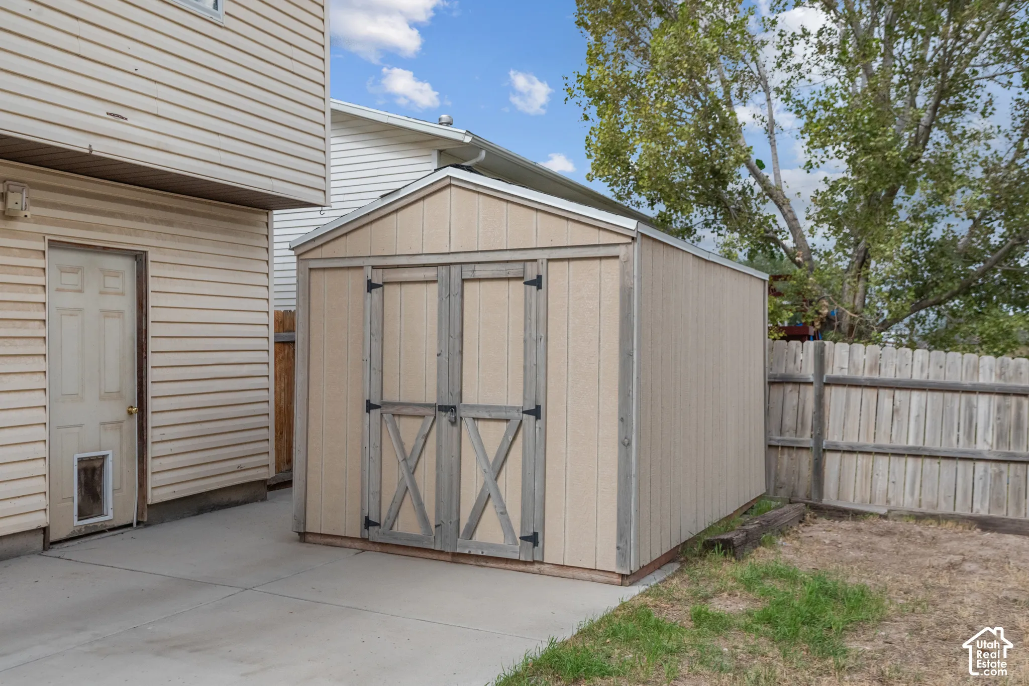 Exterior shed with double doors, wood siding, and a gabled roof