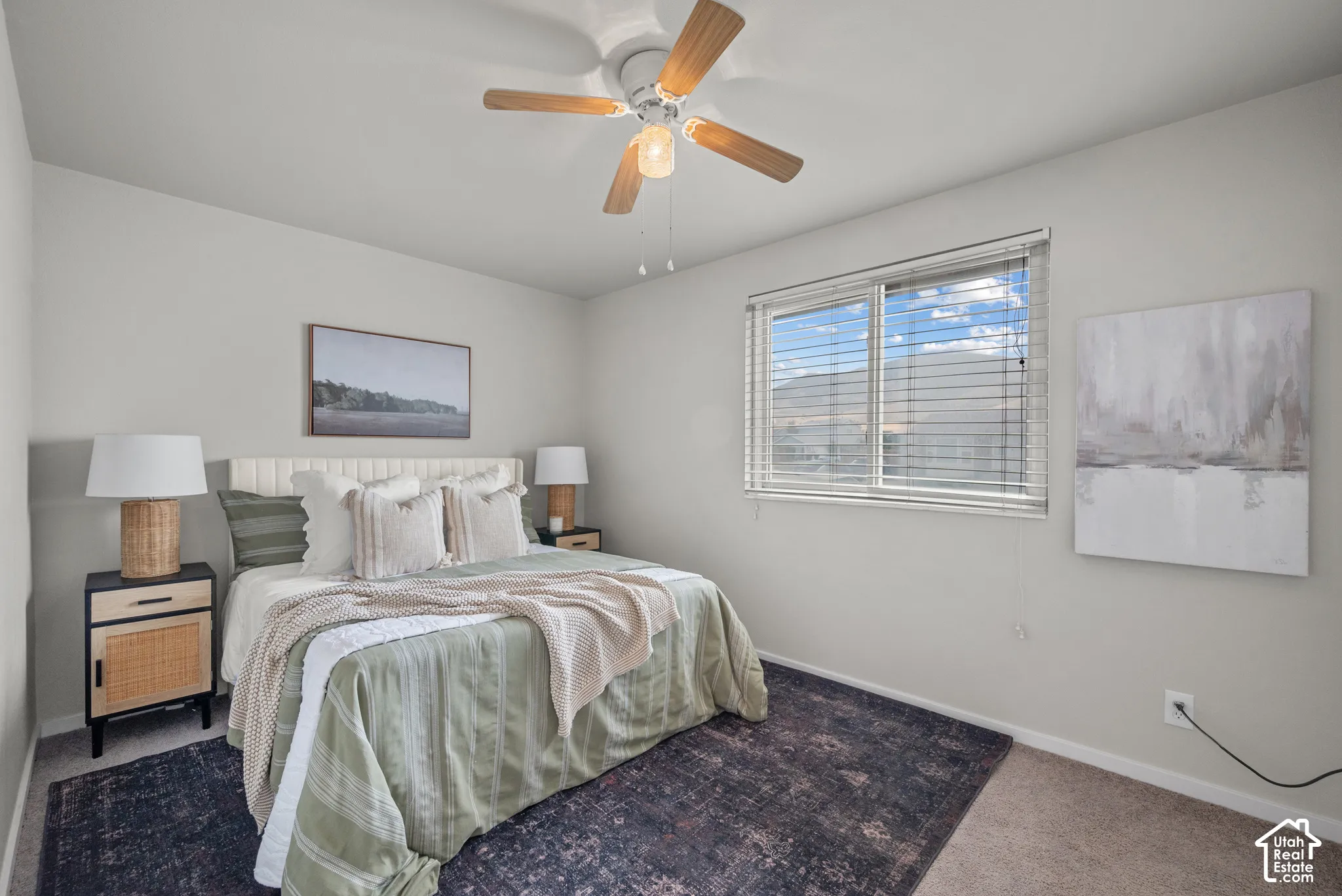 Ceiling fan with light fixture, window with blinds, light-toned walls, and carpet flooring