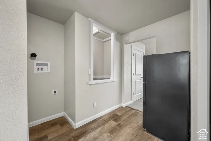 Wood-finish flooring, light gray wall paint, and white trim