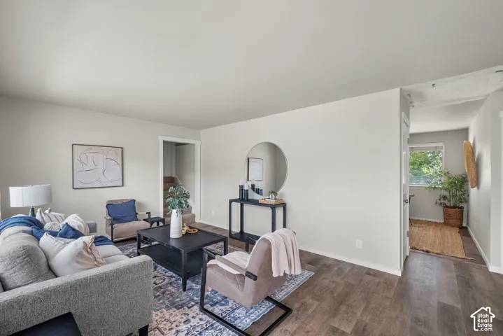 Spacious interior featuring wood-finish flooring, light-toned walls, and a staircase