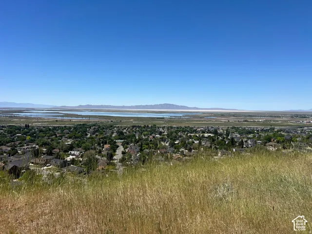 Expansive terrain featuring distant water bodies and mountain ranges