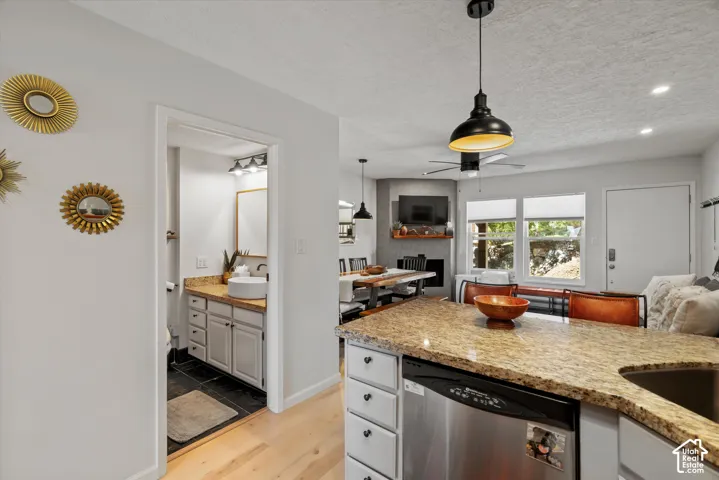 Kitchen island with granite-finish countertop and integrated stainless steel dishwasher