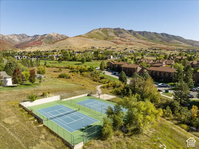 Two hard-surface tennis courts with perimeter fencing