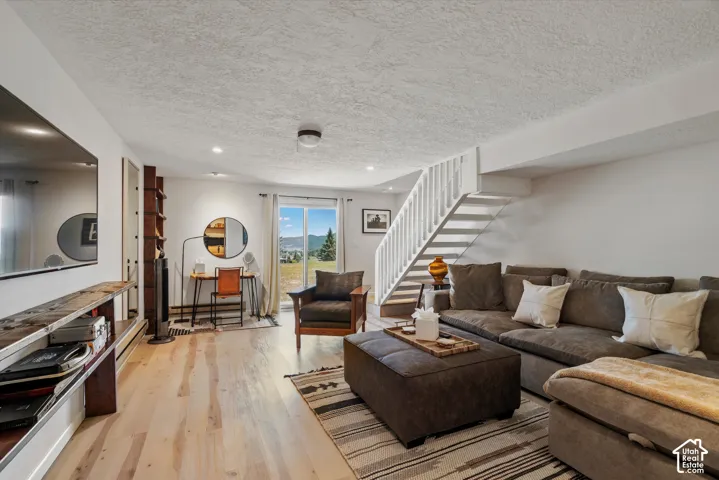Light wood-finish flooring, built-in shelving, white painted walls, and a sliding glass door