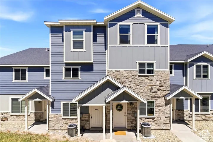Multi-level exterior featuring stone veneer and horizontal siding