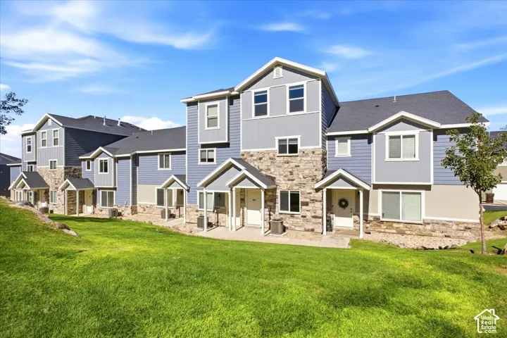 Exterior featuring mixed material facade, pitched roofs, covered entryways, and multiple windows