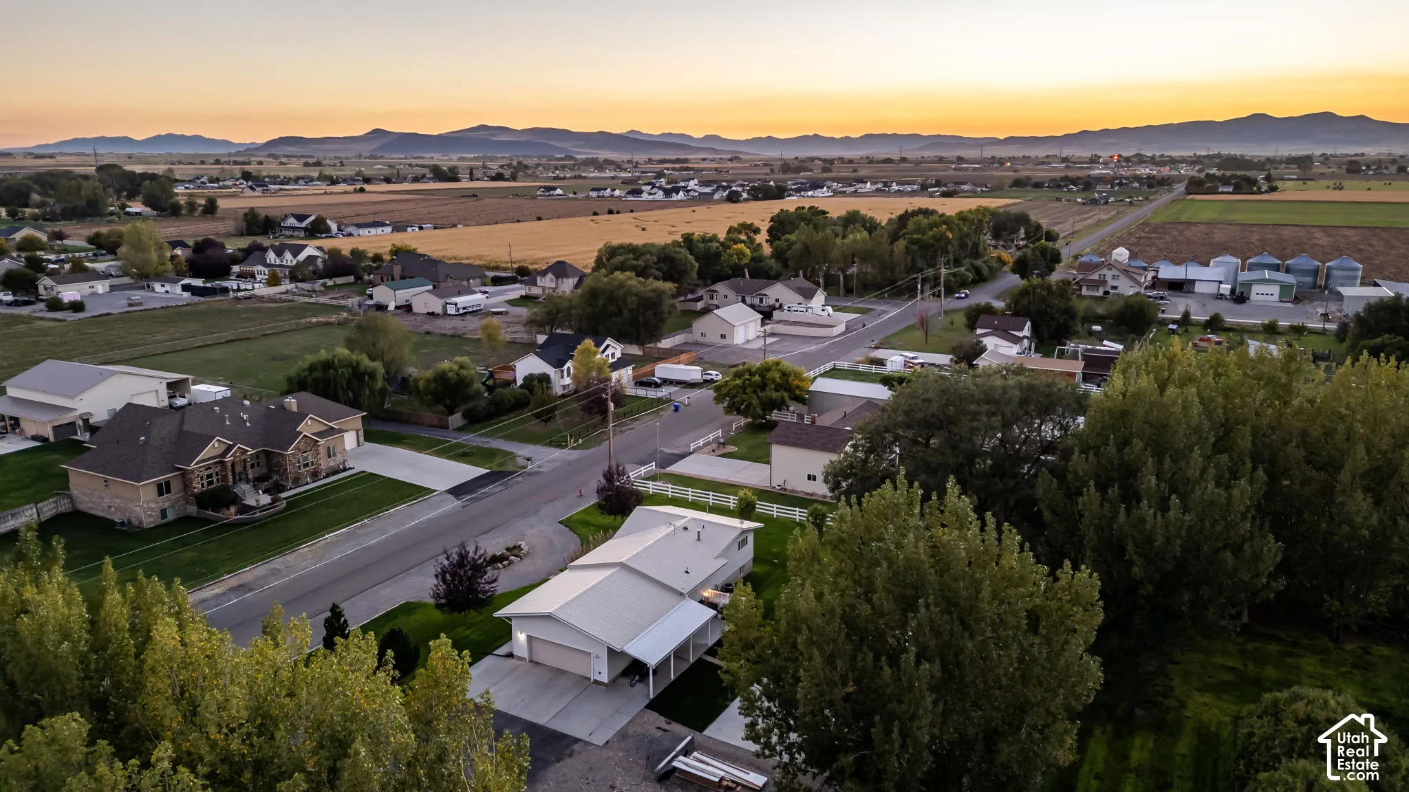 Expansive rural landscape featuring distant mountains and cultivated fields