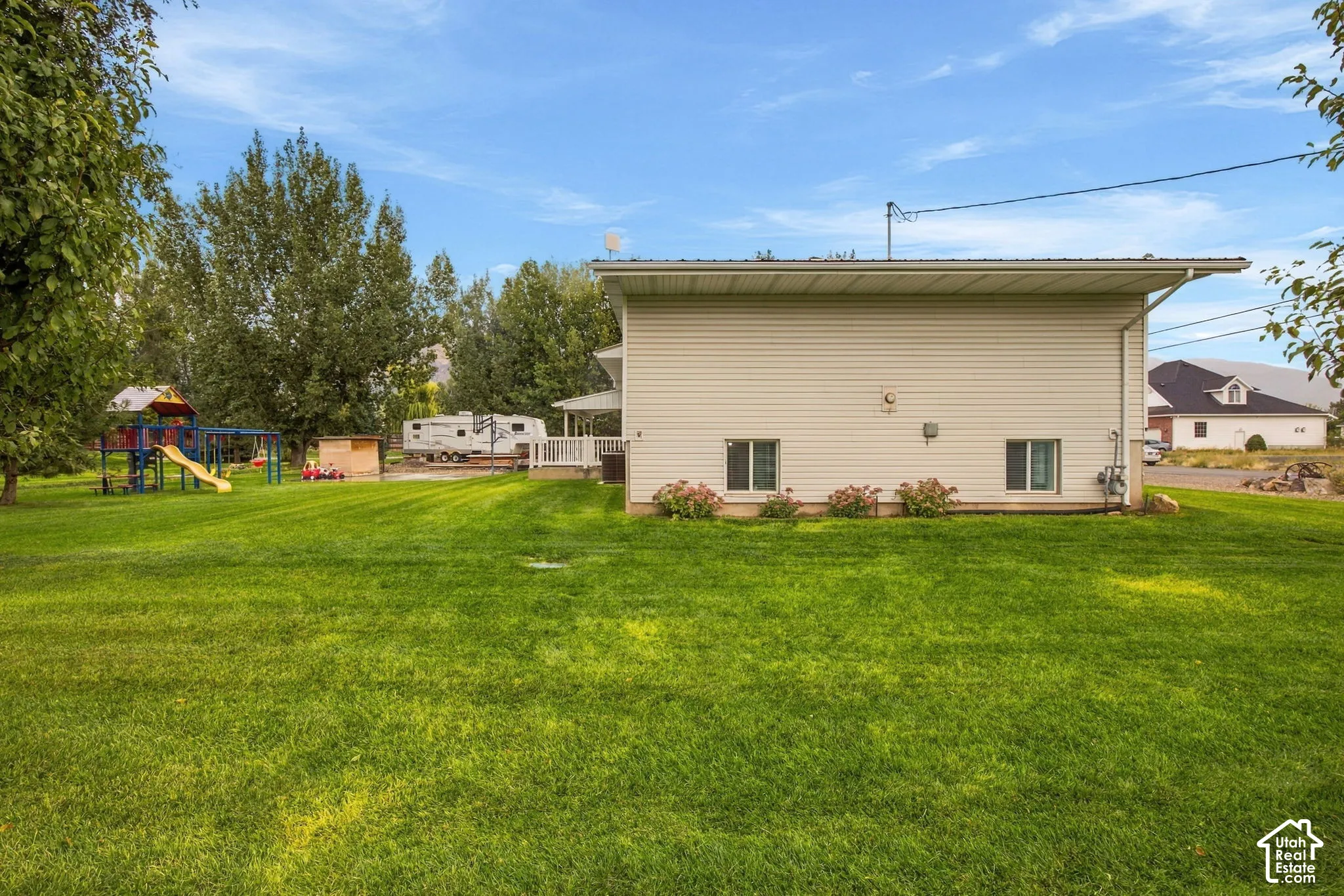 Expansive green lawn with mature trees