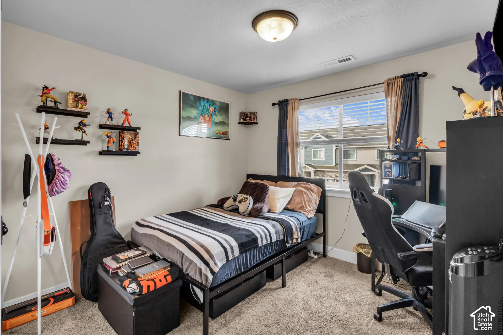 Carpeted flooring, window with blinds, wall-mounted shelving, and a ceiling-mounted light fixture