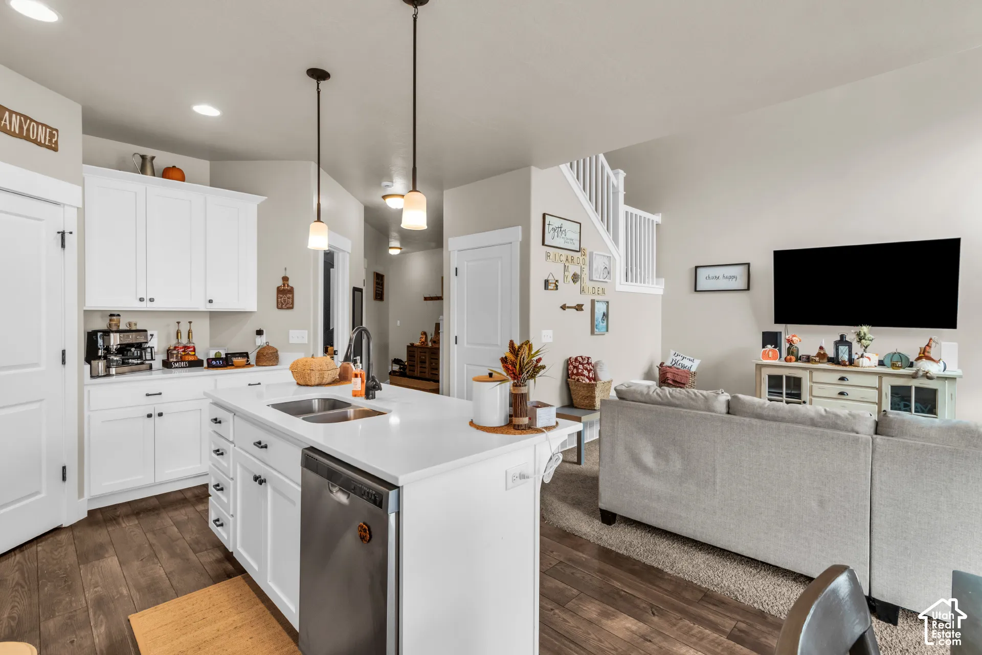 Kitchen featuring white cabinetry, a center island with sink and stainless steel dishwasher, and recessed lighting