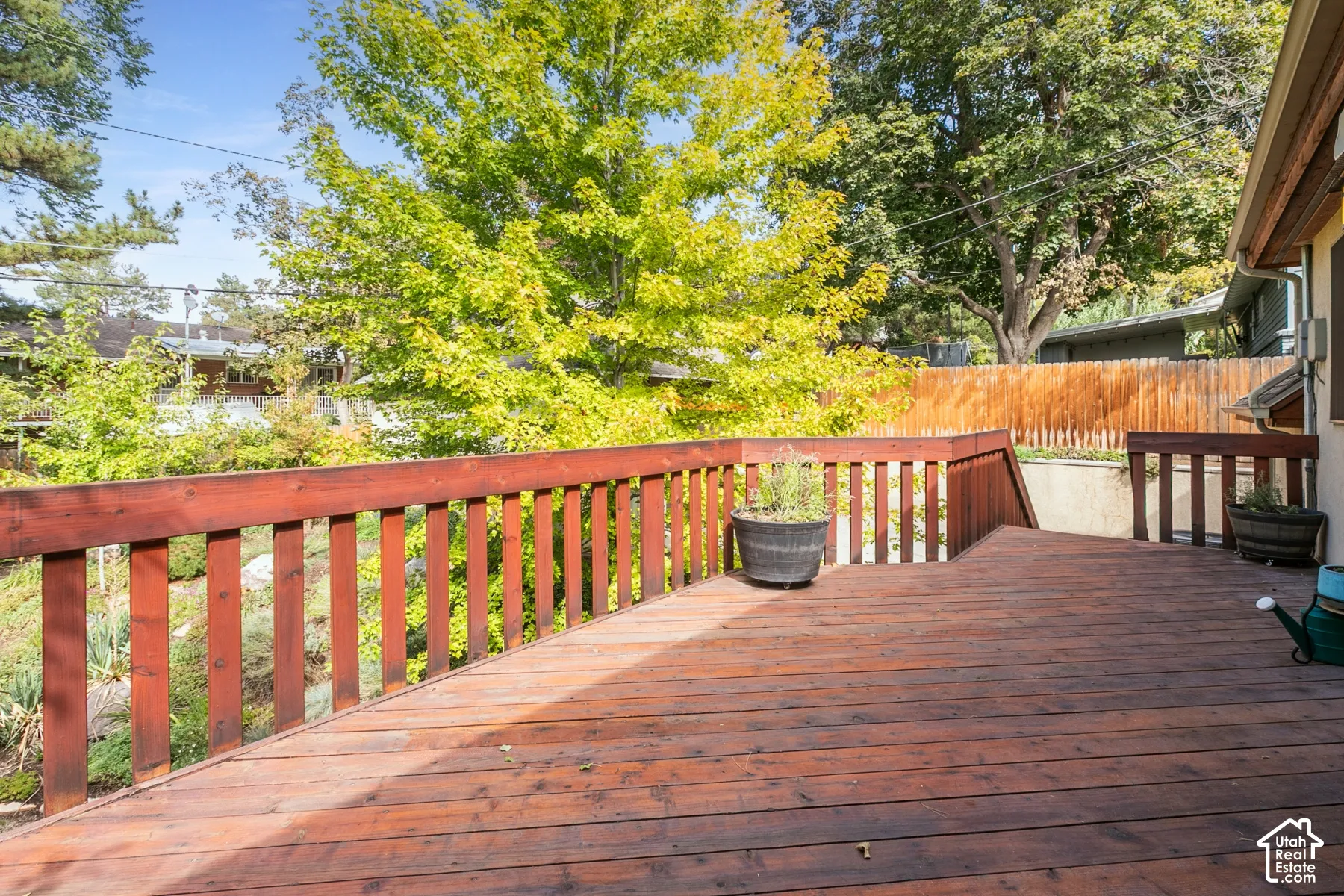 Expansive wood deck with a rich stain finish and matching wood railings