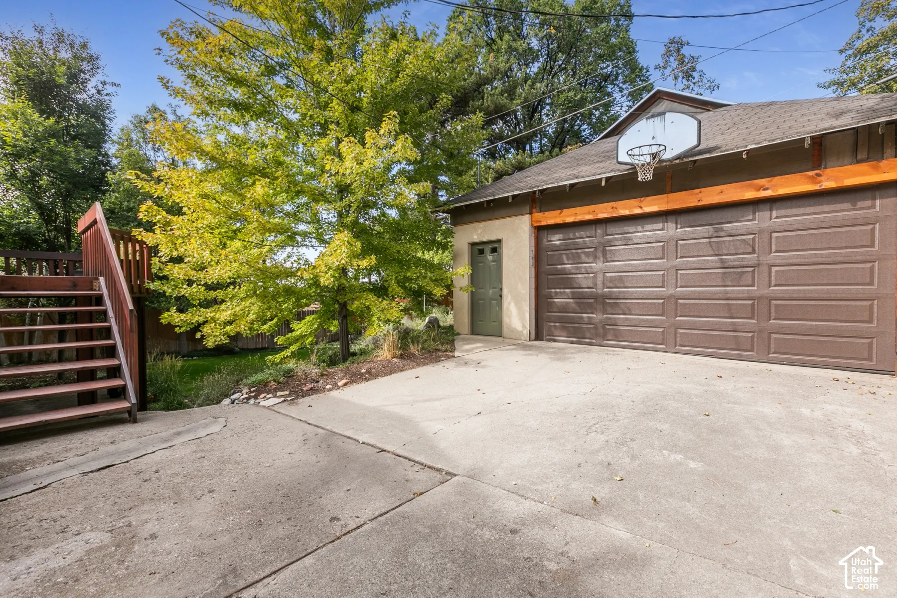 Detached garage featuring a paneled door and side entry