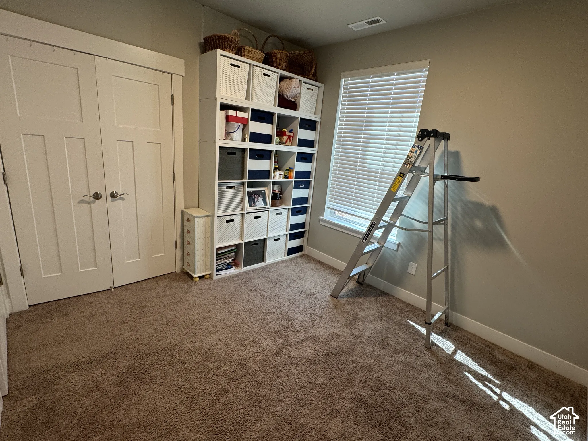 Wall-to-wall carpeting and a double-door closet with polished hardware