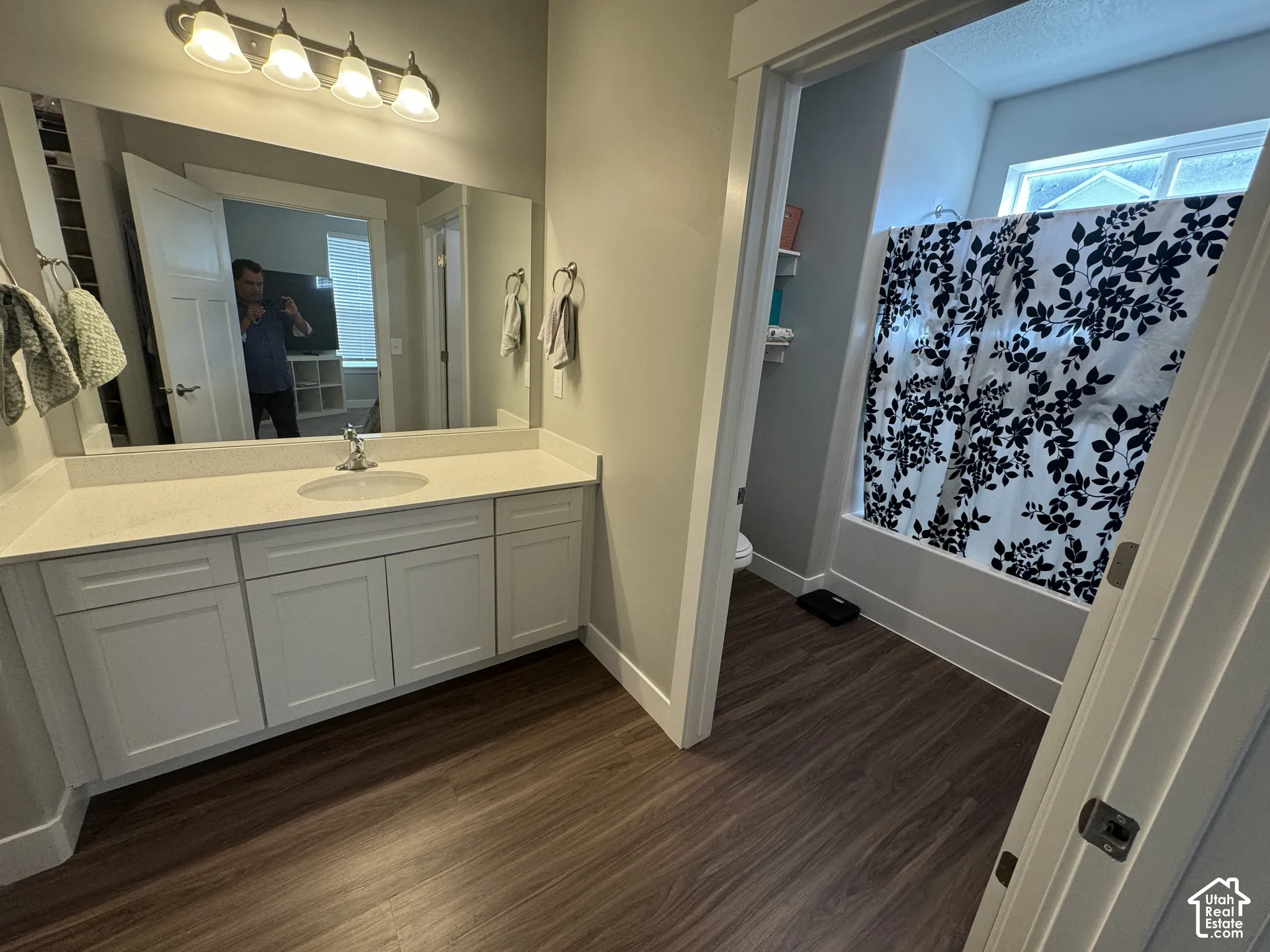 Vanity featuring a single sink, light-colored countertop, and white cabinetry