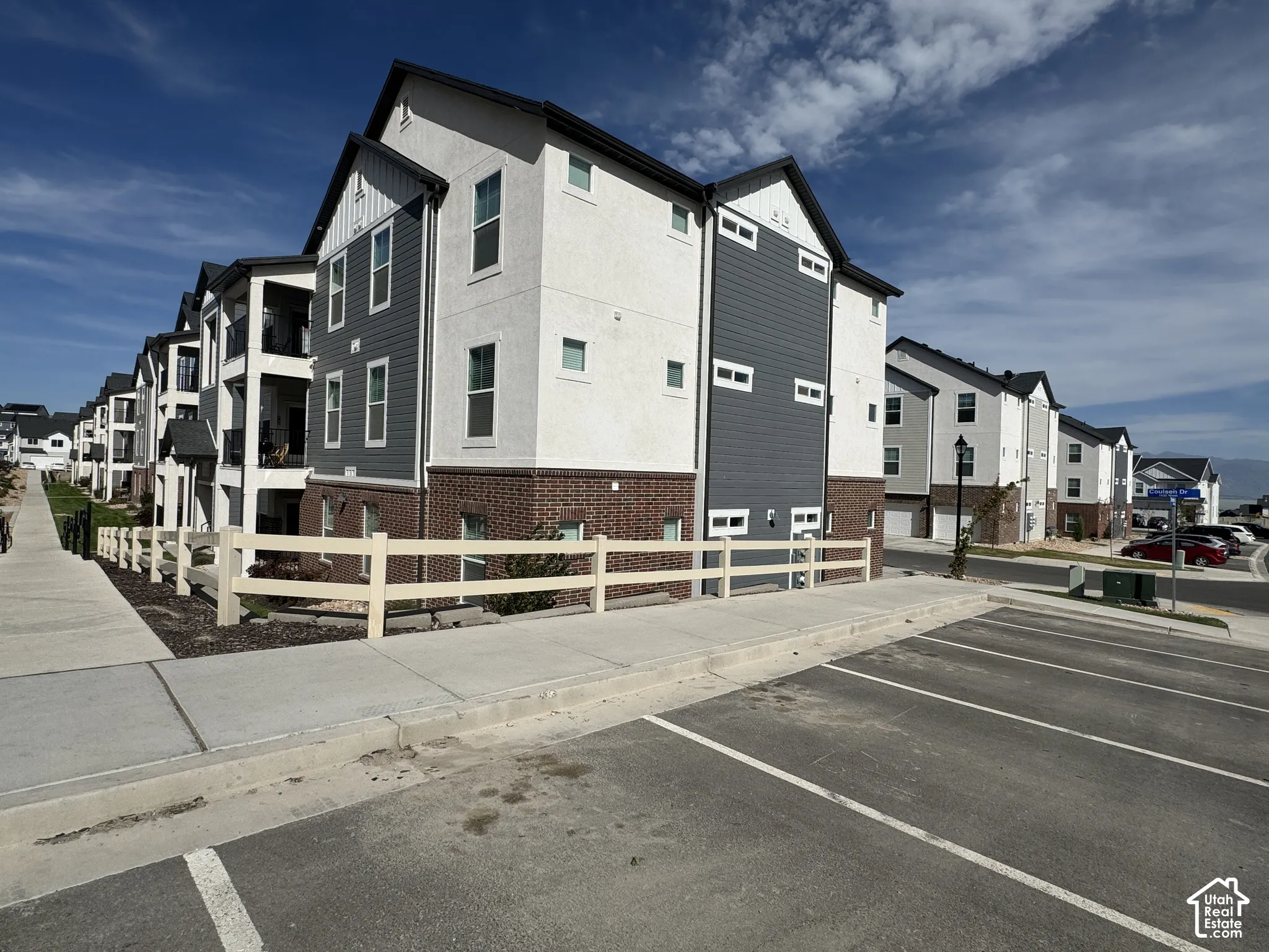 Exterior featuring brick and horizontal siding accents