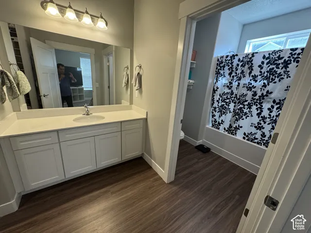 Vanity featuring a single sink, light-colored countertop, and white cabinetry