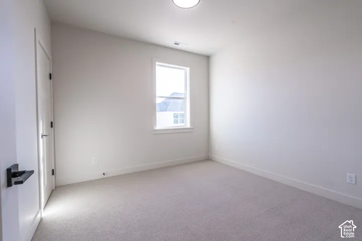 Neutral-toned walls complement the light-colored carpeting