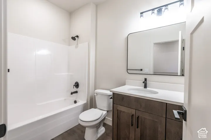 White tub and shower combination with matte black fixtures