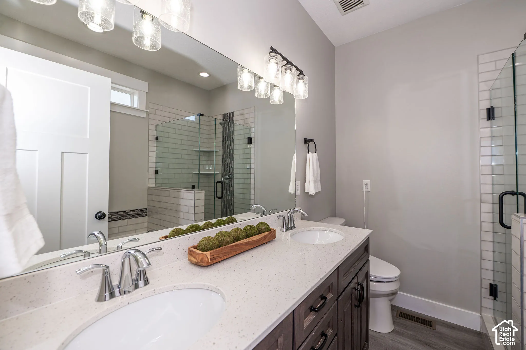 Double vanity with undermount sinks, stone-finish countertop, and chrome fixtures