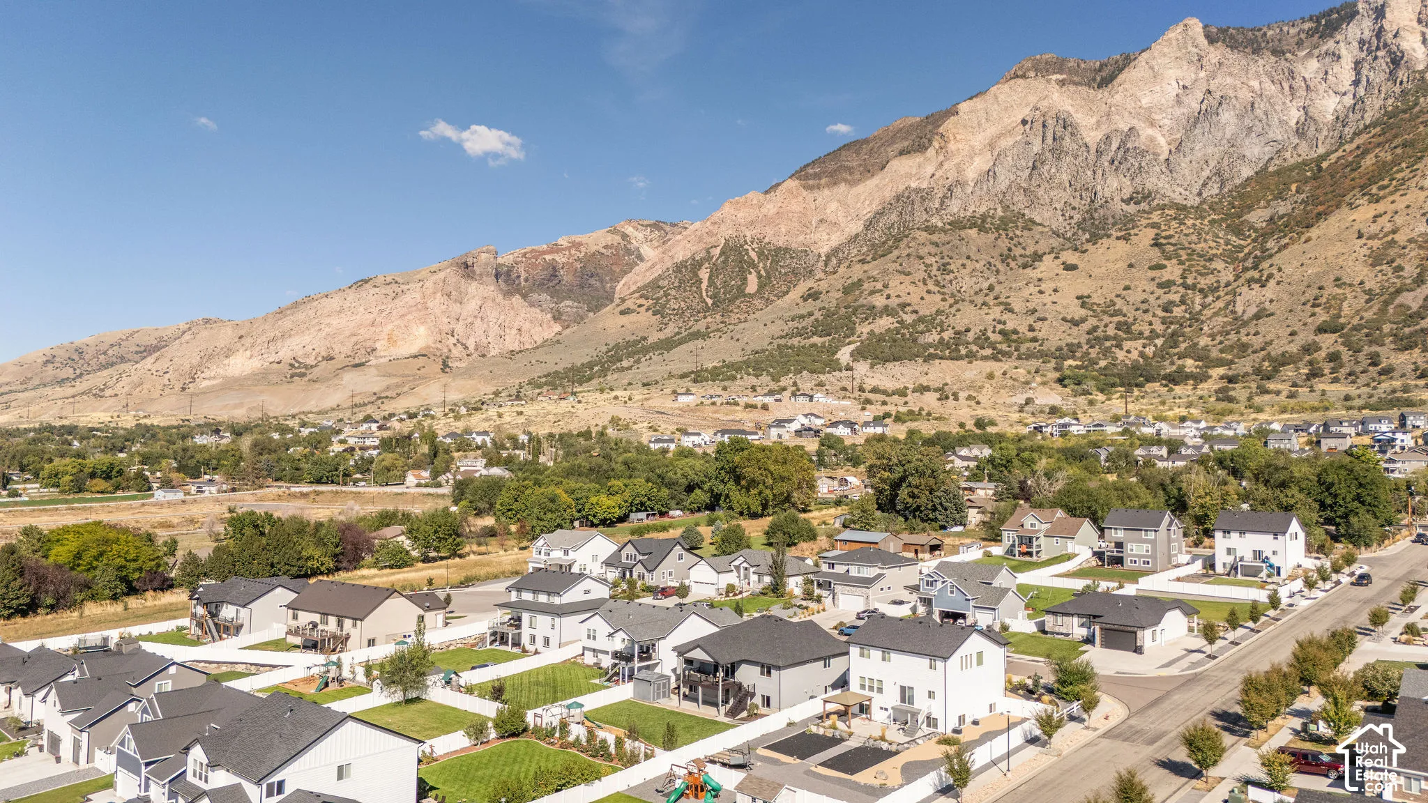 Neighborhood setting with mountain backdrop and residential homes