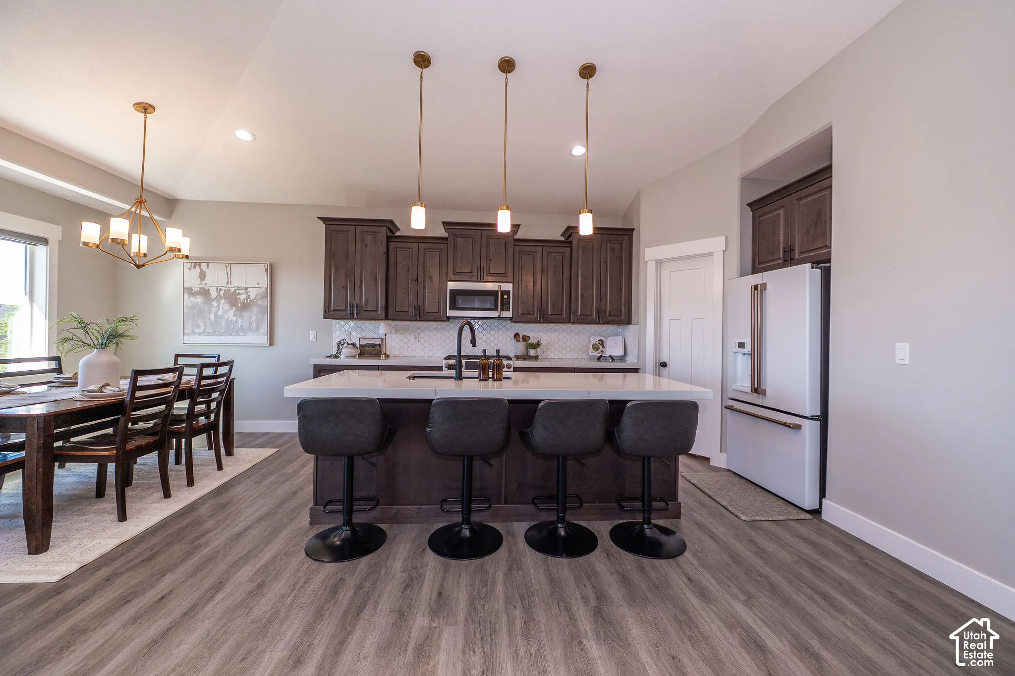 Kitchen with a center island featuring a white countertop and pendant lighting
