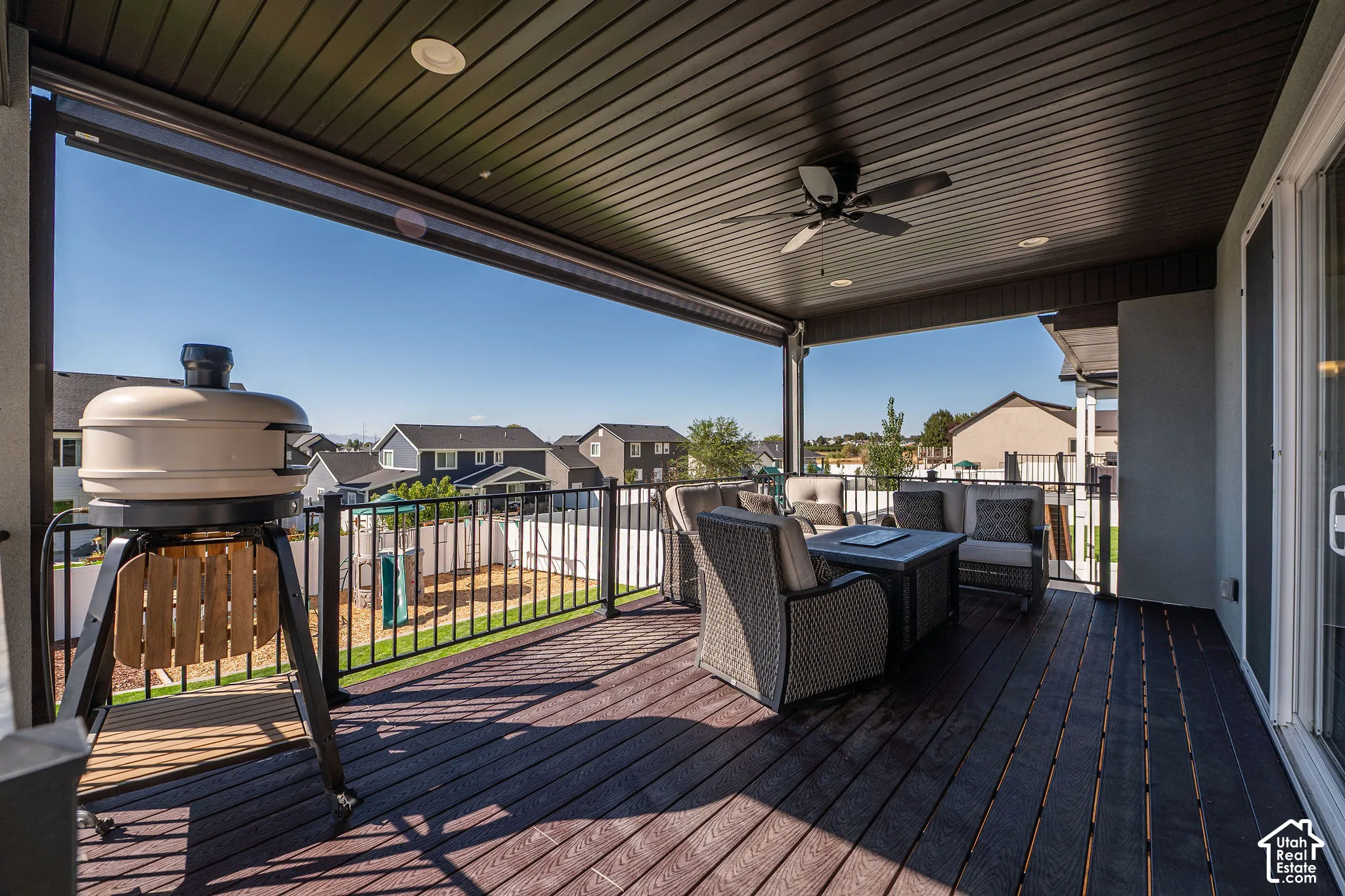 Covered outdoor deck with dark wood-finish flooring